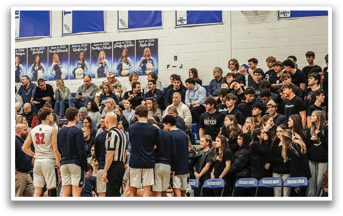 A group of people are sitting in the bleachers, watching a basketball game. AI generated content