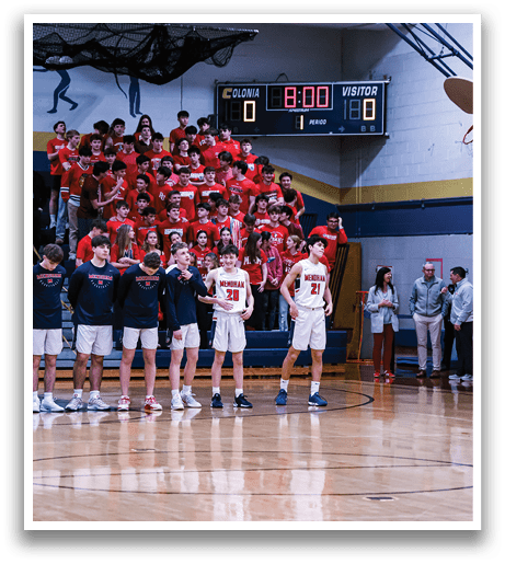 A group of young men stand on a basketball court, wearing uniforms and waiting for the game to start. AI generated content
