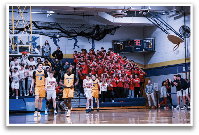 A basketball game is taking place with a crowd of people watching. The players are wearing uniforms and the crowd is cheering them on. The game is being played in a gymnasium with a clock visible on the wall. AI generated content