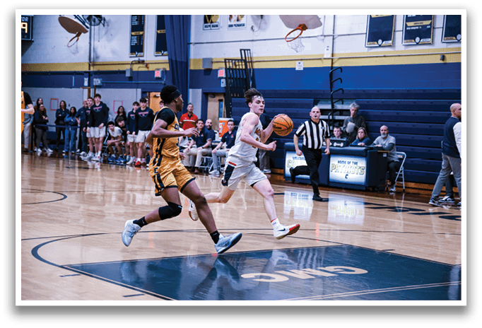 A basketball game is in progress with players on the court. A man is running with a basketball in his hand, while another player is running towards him. There are several other players on the court, some of whom are holding basketballs. A referee is also present, watching the game closely. The scene is set in a gymnasium with a crowd of spectators watching the game. AI generated content