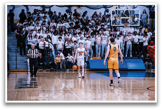 A basketball game is taking place with a crowd of people watching. The players are wearing uniforms and the referee is present. The basketball is in play and the players are actively engaged in the game. AI generated content