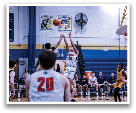 A group of men playing basketball, with one man attempting to block a shot. AI generated content