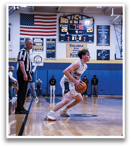 A basketball player is running with a ball in his hand, while a referee watches from behind. AI generated content