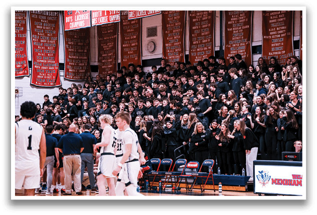 A large crowd of people are sitting in the bleachers, watching a basketball game. AI generated content