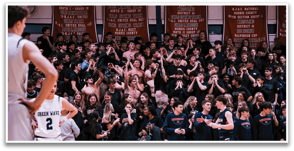 A group of people are standing in a gymnasium, with some of them wearing black shirts. The crowd is cheering and clapping, creating a lively atmosphere. AI generated content