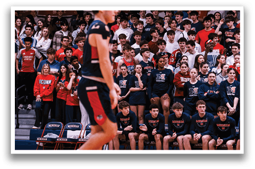 A basketball player is holding the ball while a crowd of people watch. AI generated content