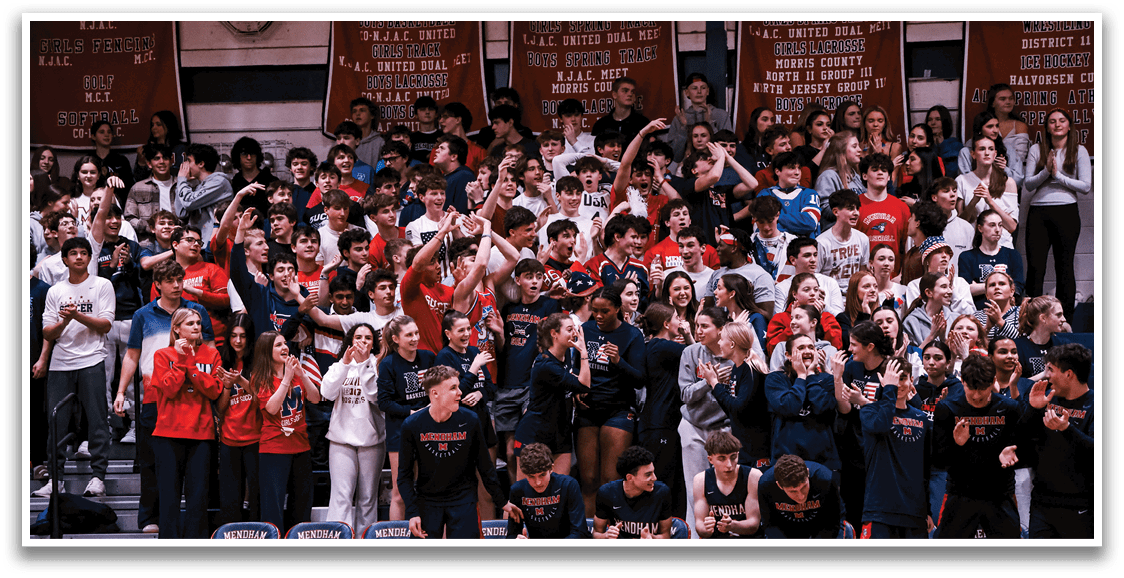 A large group of people are sitting in the bleachers, watching a game. They are all wearing red and white shirts, and some are holding up their hands in the air. The crowd is cheering and clapping, creating a lively atmosphere. AI generated content