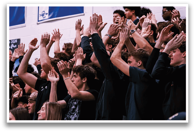 A crowd of people are in a stadium, with their hands raised in the air. AI generated content