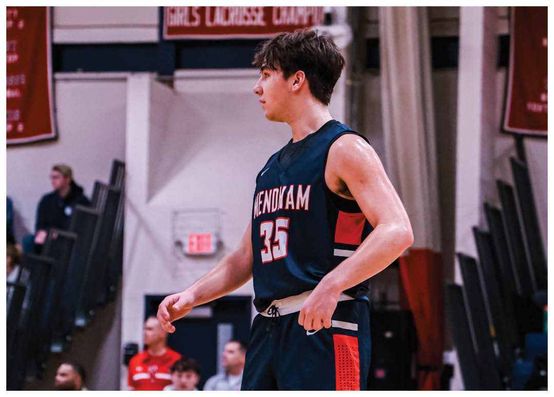 A man wearing a basketball uniform stands on a basketball court. AI generated content