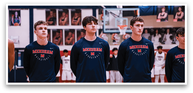 A group of young men wearing blue shirts and shorts stand on a basketball court. AI generated content
