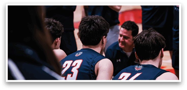A group of men wearing blue shirts and black shorts are sitting on the floor. AI generated content