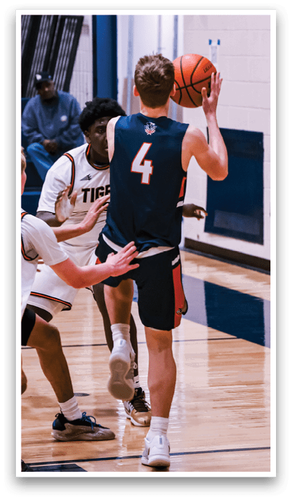 A basketball game is taking place with a player in the middle of the court holding a basketball. AI generated content