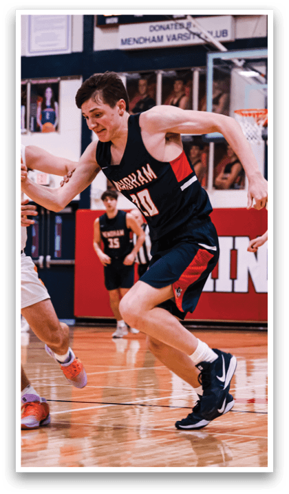 A group of young men playing basketball on a court. AI generated content