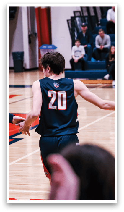 A basketball player wearing a number 20 jersey is walking on the court, shaking hands with another player. AI generated content
