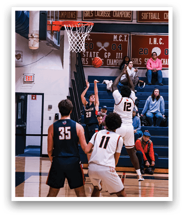 Basketball players are playing on a court with a crowd watching. One player is jumping up to shoot the ball through the net. AI generated content