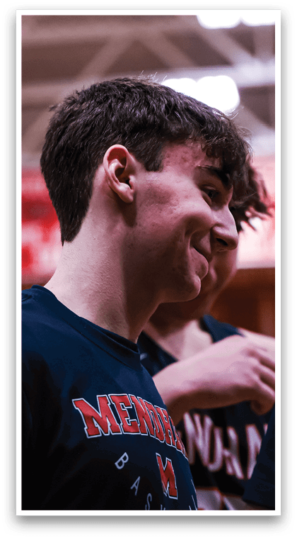 A man wearing a blue shirt with the word “Midwest" on it is smiling. AI generated content