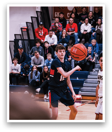 A boy in a basketball game is holding a basketball in his hands. AI generated content