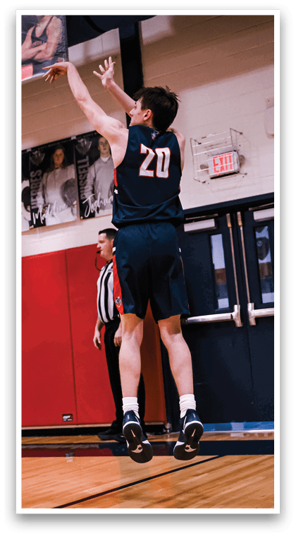 Two basketball players are playing in a gym. One player is jumping up to block the shot of the other player who is attempting to score. AI generated content