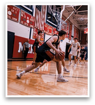 A group of young men playing basketball in a gym. AI generated content