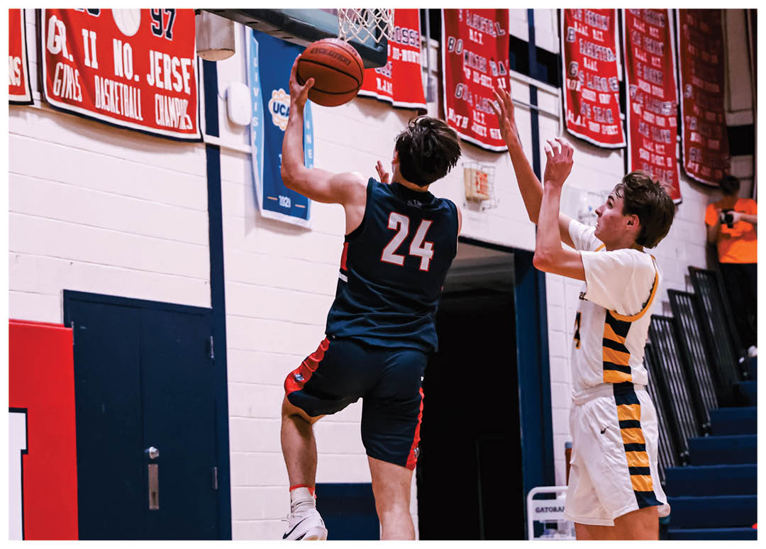 Two basketball players are jumping for the ball, one wearing a blue shirt and the other wearing a yellow shirt. AI generated content