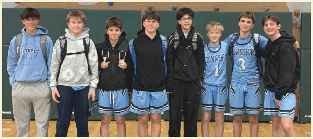 A group of young men wearing blue uniforms pose for a photo on a basketball court. AI generated content