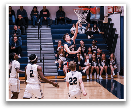 A basketball player is jumping to block a shot, while the opposing team looks on. AI generated content