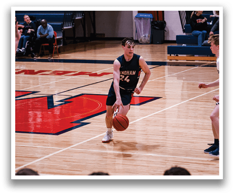 A basketball player wearing a black jersey with the number 24 is holding a basketball on the court. AI generated content