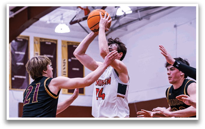 A basketball game is in progress with players on the court. One player is attempting to shoot the ball while two other players try to block his shot. The crowd watches intently as the players compete. AI generated content