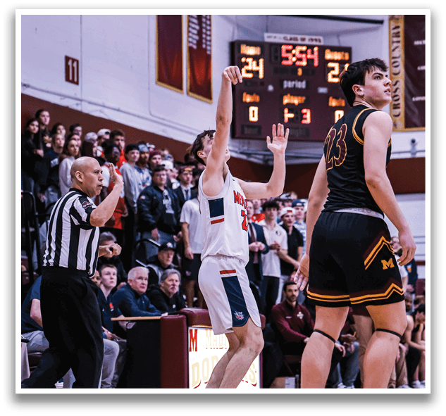 A basketball game is in progress with a crowd of people watching. A man is holding his hand up in the air, possibly signaling a play. Another man is holding his hand up as well, possibly indicating a call. The players are wearing uniforms and the game is being played on a basketball court. AI generated content