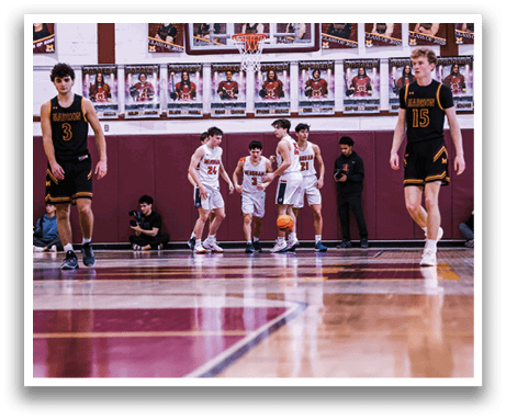 A group of young men playing basketball on a court. AI generated content