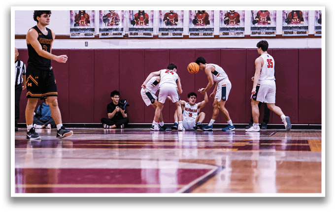 Basketball players on a court, one of them is sitting on the ground. AI generated content