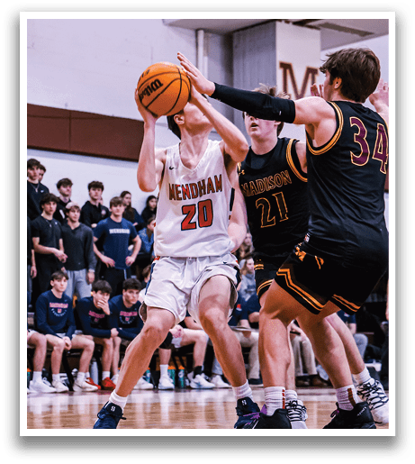 A basketball game is in progress with two teams playing. One player is attempting to shoot the ball while another player tries to block the shot. The crowd watches intently as the players compete. AI generated content