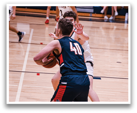 Two men playing basketball on a court, one of them wearing a blue jersey with the number 40. AI generated content