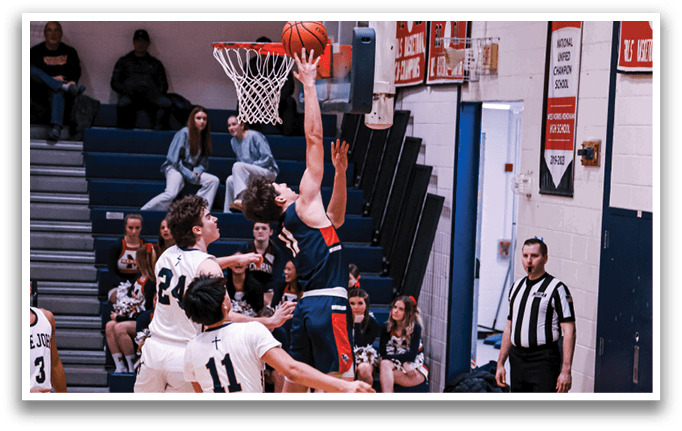 A basketball player jumps to block a shot, while the referee watches closely. AI generated content