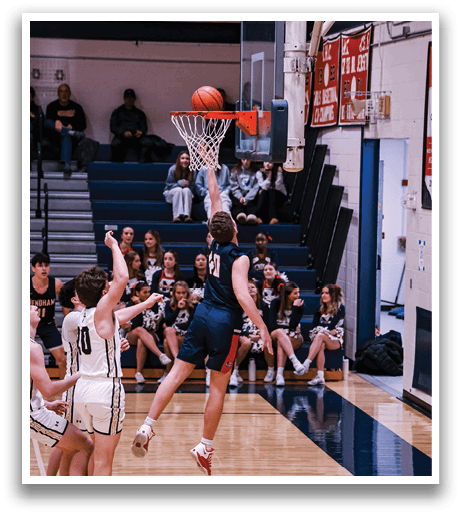 A basketball player leaps into the air to block a shot, while other players look on. AI generated content