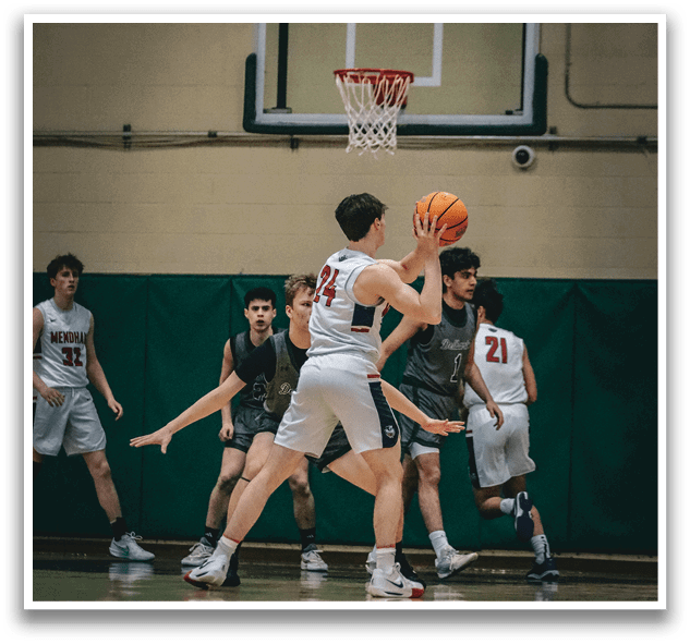 A group of men playing basketball on a court. One man is attempting to shoot the ball through the hoop. AI generated content