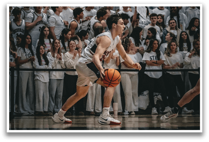 A basketball player in a white uniform is running with a basketball in his hand. AI generated content