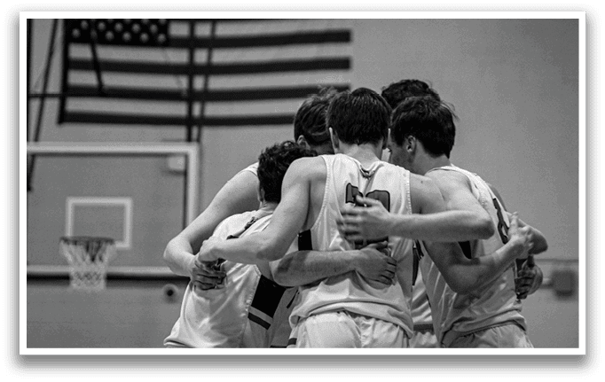 A group of young men huddle together on a basketball court, wearing white uniforms. AI generated content