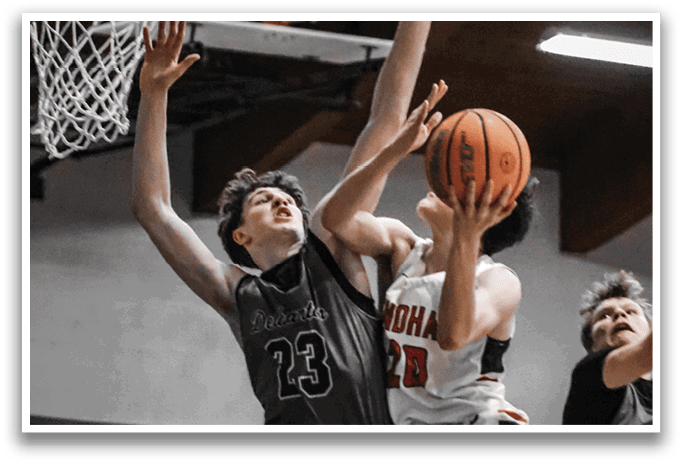 Two basketball players are leaping for the ball, with one player reaching for the basketball and the other trying to block the shot. AI generated content