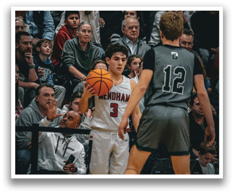 A basketball player holds a basketball while standing in front of a crowd. AI generated content