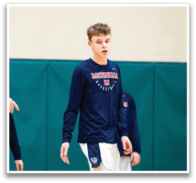 A man wearing a blue shirt with the word “Michigan" on it walks on a basketball court. AI generated content
