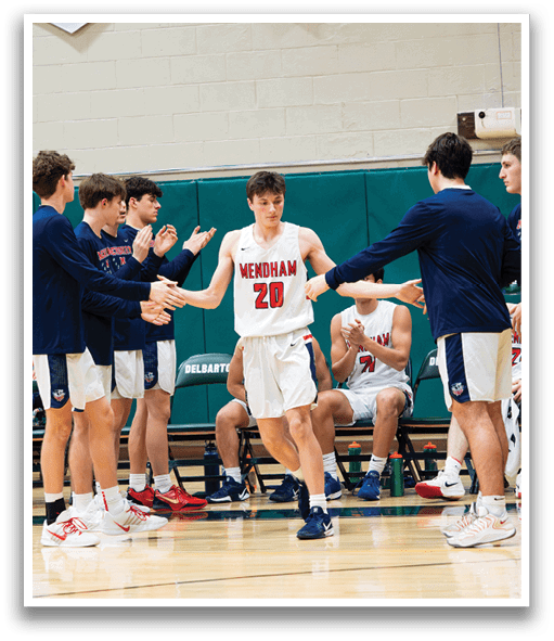 A group of young men are on a basketball court, with one of them holding a basketball. They are wearing uniforms and are in the middle of a game. AI generated content