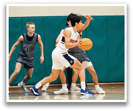 Two men playing basketball, one holding a ball, the other trying to block him. AI generated content