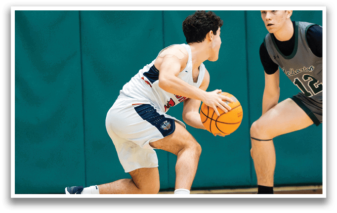 Two boys playing basketball, one holding a basketball and the other trying to block him. AI generated content