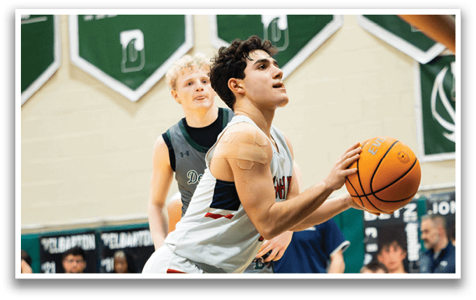 A basketball player is holding a ball while another player looks on. AI generated content