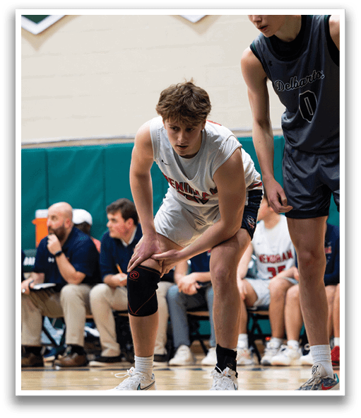 Two basketball players on the court, one with a knee brace. AI generated content