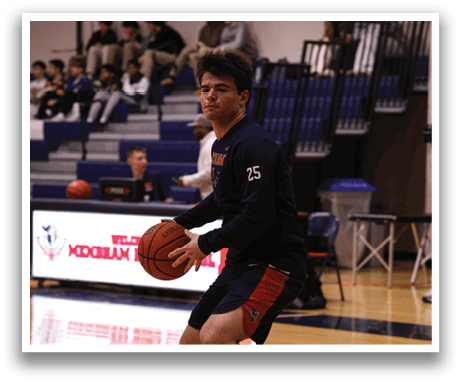 A young man is holding a basketball on a basketball court. AI generated content