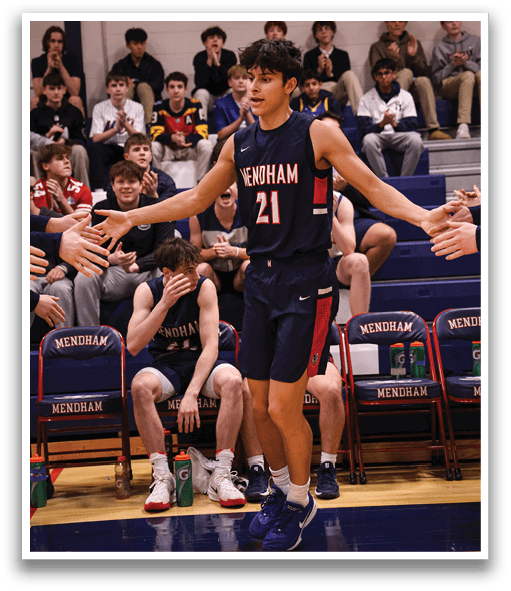 A basketball player wearing a blue uniform stands on the court holding his arms out to the crowd. AI generated content