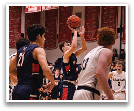 A basketball player in a blue uniform shoots a basket while other players watch. AI generated content