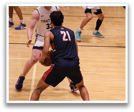 Two basketball players are playing on a court. One player is wearing a blue shirt and the other is wearing a red shirt. The player in the blue shirt is holding a basketball. AI generated content